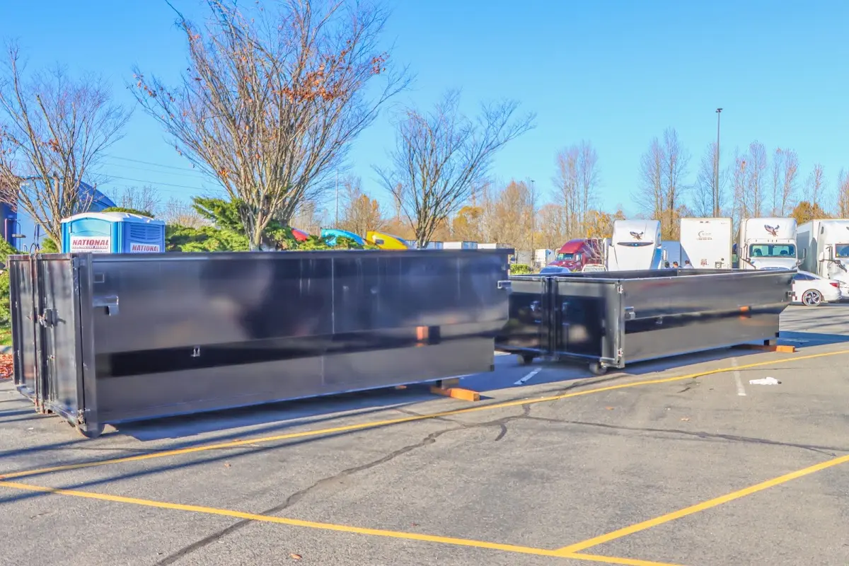 Professional dumpster rental service with roll-off container on residential driveway in Weatherford